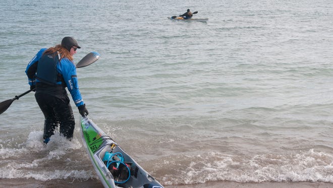 Traci Lynn Martin pulls her kayak into Lake Huron as she launches at Lighthouse Beach in Port Huron