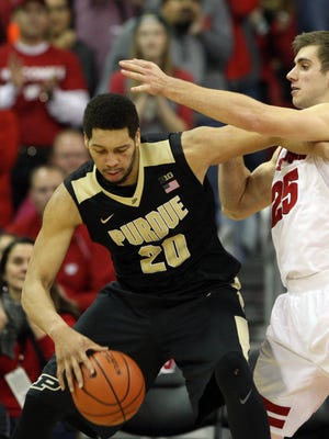 Dec 29, 2015; Madison, WI, USA; Purdue Boilermakers center A.J. Hammons (20) works the ball against Wisconsin Badgers forward Alex Illikainen (25) at the Kohl Center. Purdue defeated Wisconsin 61-55.  Mandatory Credit: Mary Langenfeld-USA TODAY Sports