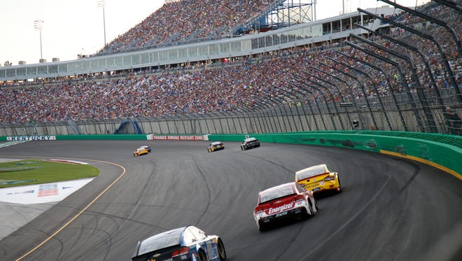 NASCAR drivers approach the start/finish line during the Quaker State 400 presented by Advance Auto Parts, Saturday, July 9, 2016, at the Kentucky Speedway in Sparta, Ky.