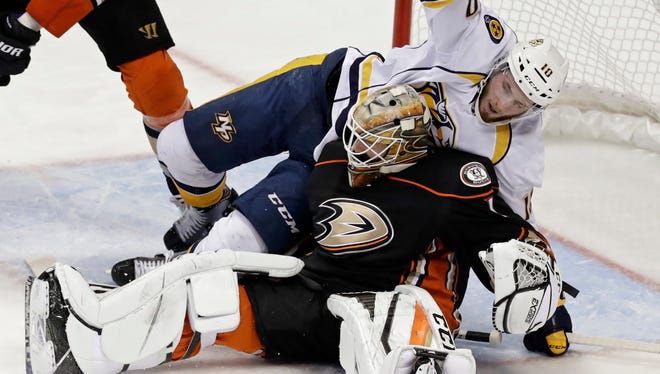 Predators center Colton Sissons falls onto Ducks goalie Jonathan Bernier during the second period of Game 5 on Saturday.