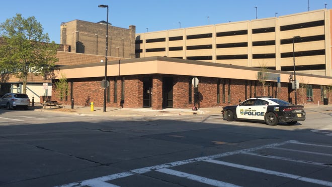 A squad car blocks off an area outside the Cherry Street parking ramp  Tuesday morning.