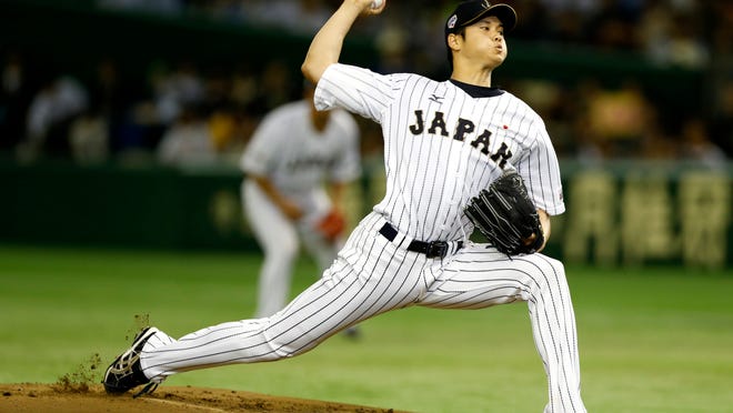 FILE - In this Nov. 19, 2015, file photo, Japan's starter Shohei Otani pitches against South Korea during the first inning of their semifinal game at the Premier12 world baseball tournament at Tokyo Dome in Tokyo. Shohei Otani is likely to leave Japan and sign with a Major League Baseball team after this season, multiple reports in Japanese media said Wednesday, Sept. 13, 2017, a move that would cost the 23-year-old pitcher and outfielder more than $100 million.  (AP Photo/Toru Takahashi, File)