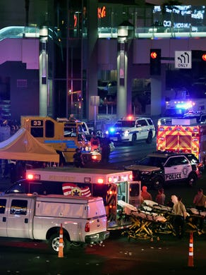 Police and rescue personnel gather at the intersection of Las Vegas Boulevard and Tropicana Ave.
