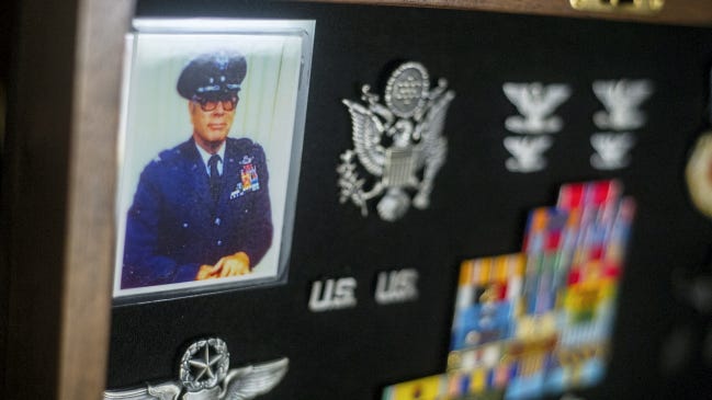 A picture of pilot Arthur Cunningham in uniform and assorted medals and pins line one tray of what the 94-year-old calls the 'me' box May 7.