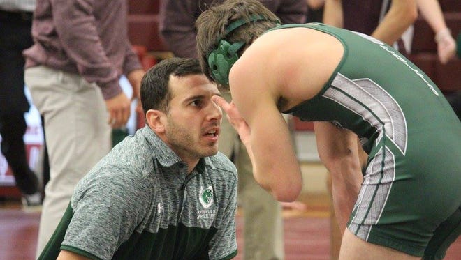 Kinnelon head wrestling coach Eric DiColo speaks with sophomore Ethan Harriz during a recent match. DiColo and his Colts are 9-5 heading into tonight's NJAC-Independence matchup against neighboring rivals Butler.