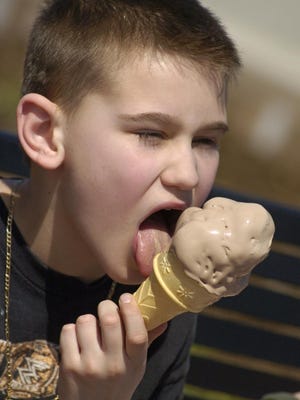 From the archive: Elvis Gujic, 10, Irondequoit, enjoys a mouthful of Abbott's frozen custard as he and his family make the most of the warm and sunny weather by spending their morning at Ontario Beach Park in Rochester in April 2008.