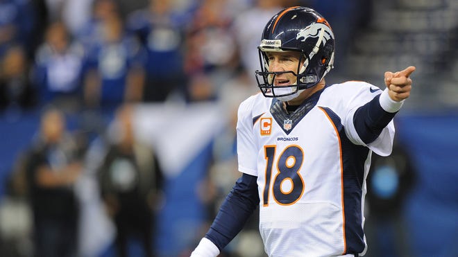 Denver Broncos' Peyton Manning (18) directs the offense.