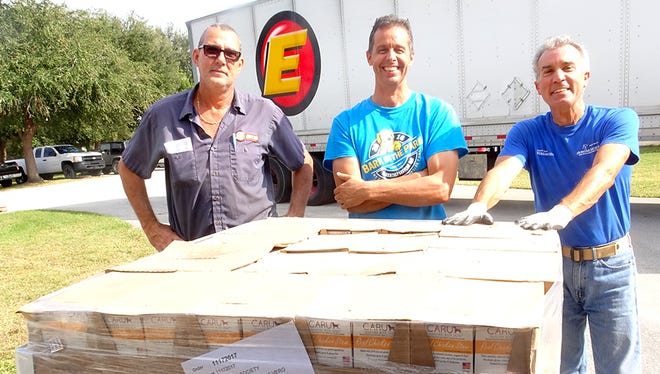 Staff at the Humane Society of Vero Beach & Indian River County gratefully unload a shipment of Caru Pet Food.