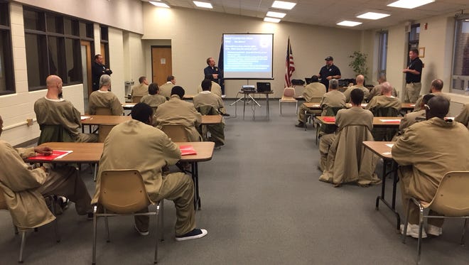 These 21 inmates at Putnamville Correctional Facility are due to return to live in Indianapolis within the next three months. Before their departure, they met with an IMPD officer and parole agents on Dec. 9, 2015, for a message about returning to the outside world.