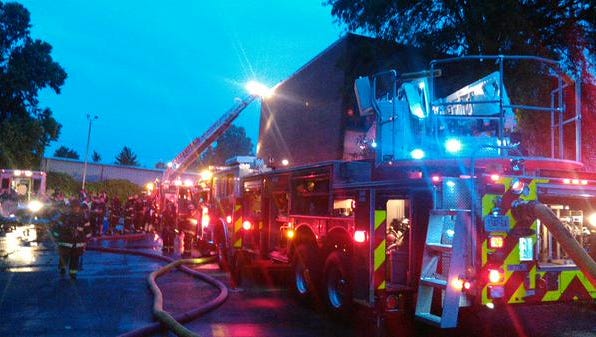 Firefighters respond to a fire at an abandoned inn on Harding Place Tuesday night, which investigators believe was deliberately started.