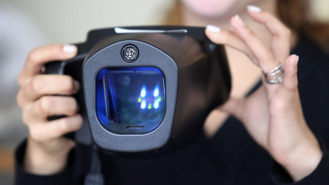 Madison Sisk uses a Spot Vision Scanner while testing elementary students' vision at Chapman Hill Elementary on Thursday, Nov. 12, 2015, in Salem, Ore. 