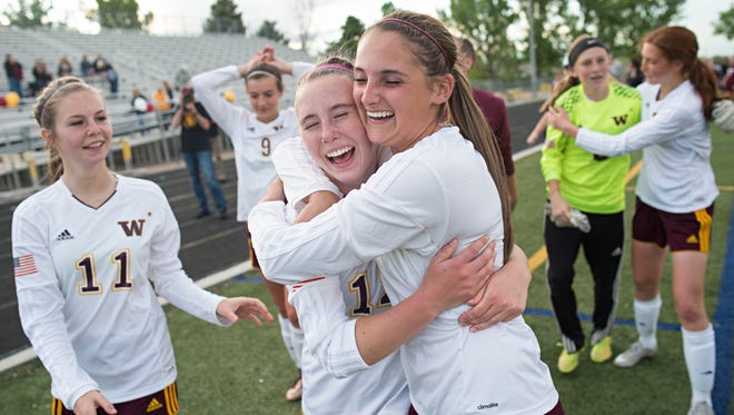Abby Gearhart and Sarah Johnson of Windsor High School celebrate a 3-2 win over Cheyenne Mountain in the class 4A state quarterfinals in Windsor Thursday, May 19, 2016. 