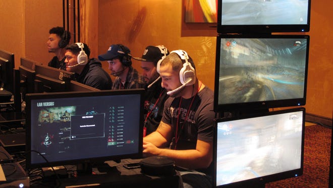 Video game players compete against one another in an esports tournament at Caesars casino in Atlantic City, N.J.