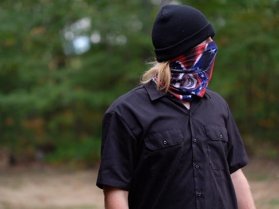 A white supremacist with the Stormfront group attends