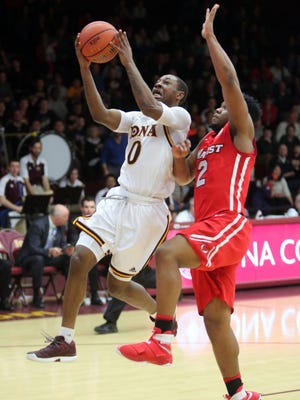 Iona's Rickey McGill goes up for a shot in front of Marist's Brian Parker during their game at Iona College, Dec. 31, 2016.