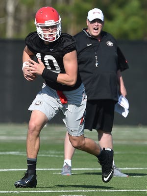 Georgia freshman quarterback Jacob Eason gets feedback from offensive coordinator Jim Chaney during the first day of spring NCAA college football practice, Tuesday March 15, 2016, in Athens, Ga. (Brant Sanderlin/Atlanta Journal-Constitution via AP)