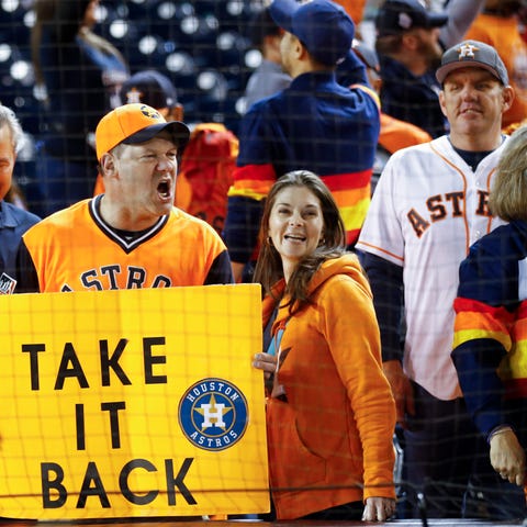 Houston Astros fans cheer after Game 5 of the base