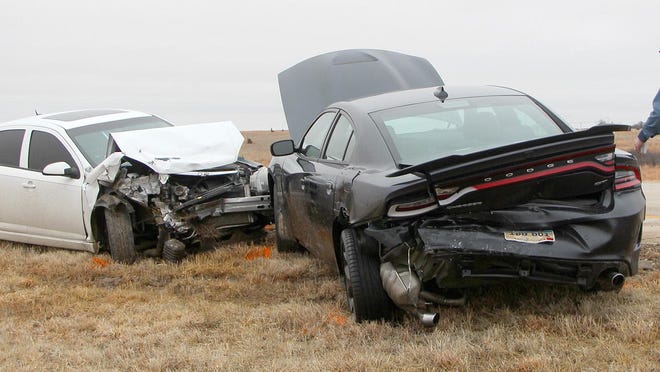 Kansas Highway Patrol Technical Trooper Mark Crump walks towards a 2016 Dodge Charger and 2008 Chevrolet Cobalt to gather vehicle information after Chevrolet rear-ended the Dodge after passing another vehicle on East U.S. 54 Monday morning.