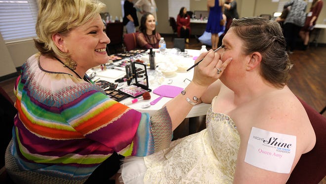 Charisse Burton, left, puts makeup on Amy Freeman in the hair and makeup room during the Night to Shine Prom on Friday, Feb. 10, 2017, at the south campus of Beltway Park Church.