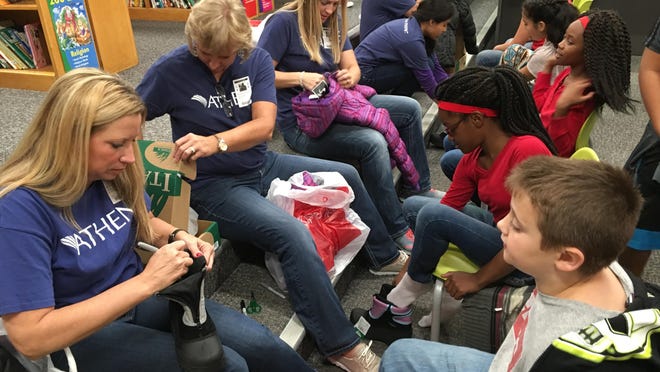 Athene employees came to Howe Elementary on Oct. 26 and fitted every student with new coats and boots. Pictured are Jennifer Morris, Tyler Virden, Jennifer Mellott, Aaliyah McGee, Dawn Young and Jamiah Wiggins.