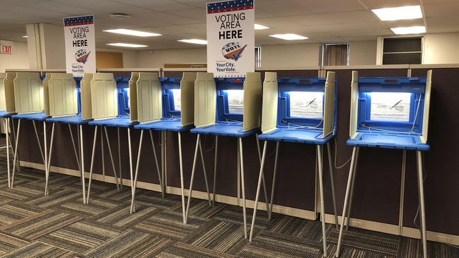In this Sept. 20, 2018 photo, voting booths stand ready in downtown Minneapolis for the opening of early voting in Minnesota. A majority of Americans are concerned that a foreign government might interfere in some way in the 2020 presidential election, whether by tampering with election results, stealing information or by influencing candidates or voter opinion, a new poll shows.(AP Photo/Steve Karnowski)