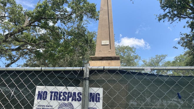 The city of St. Augustine's Confederate memorial, which displays the names of local men who died serving the Confederacy, stands behind a fence in the Plaza de la Constitucion on Tuesday.