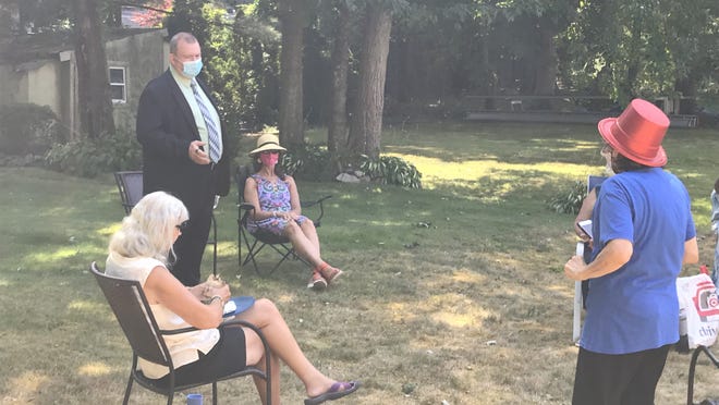 State Representative candidate Paul Hennessy answers questions at Randolph Dems barbecue on Aug. 8, which practiced social distancing. (Pictured): Randolph Dems member Sandy Slavet, Hennessy, Hennessy's partner, Randolph Dems Vice Chair Toby Lynne Schwartz (standing).