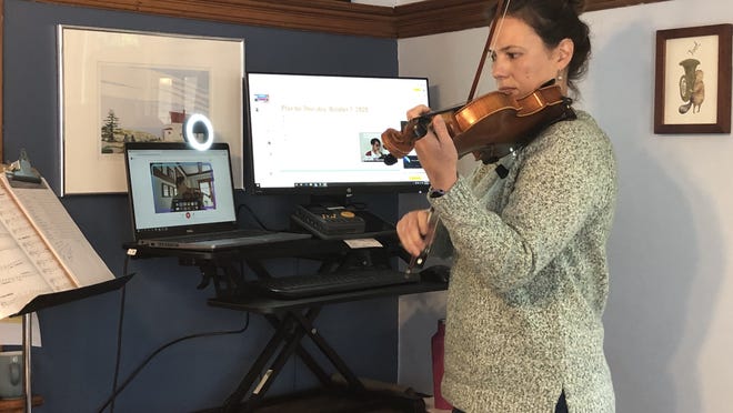 Margot Reavey, orchestra director, teaching remotely.