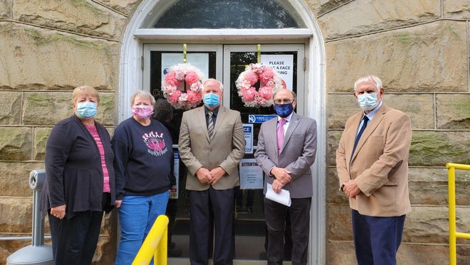 Shirley Tasker, CEOS Family Committee chairperson; Nancy Kelly, Limestone CEOS Club president, and Mineral County Commissioners Jerry Whisner, Dr. Richard Lechliter, and Roger Leatherman stand in front of the wreaths placed on the courthouse doors in observance of Breast Cancer Awareness Month.