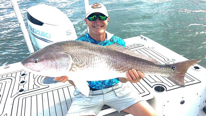 Dr. Brian Komblatt, an emergency room physician from the Savannah area, is all smiles as he shows this trophy red he landed while he, along with his brother Oscar of Colorado Springs, Colorado, went fishing with Capt. Garrett Ross.