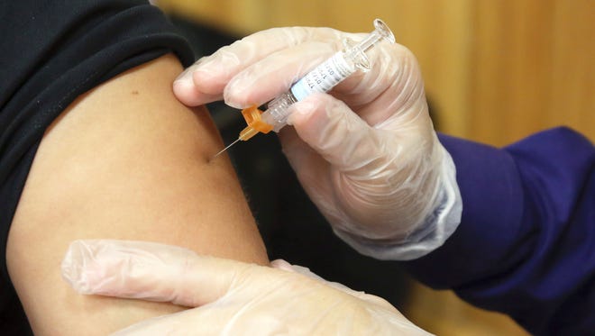 A flu vaccine injection is administered at the Brownsville Events Center by a pharmacist in Brownsville, Texas in September. According to data released by the Centers for Disease Control and Prevention on Friday, Dec. 8, 2017, this year's flu season is off to a quick start and so far it seems to be dominated by a nasty bug.