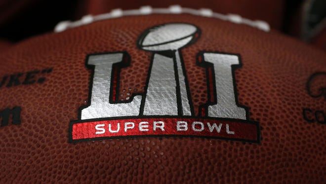 The first NFL Super Bowl LI football sits in a bin with other balls to be stamped with the New England Patriots and Atlanta Falcons names at the Wilson Sporting Goods factory Sunday, Jan. 22, 2017, in Ada, Ohio.