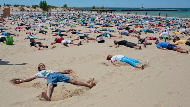 Michael Schmelter of Canton, Mich. was one of 1,414 participate in the Guinness World Record attempt for simultaneously making sand angels at Stearns Park Beach on Saturday, June 10, 2017 in Ludinton, Mich.
