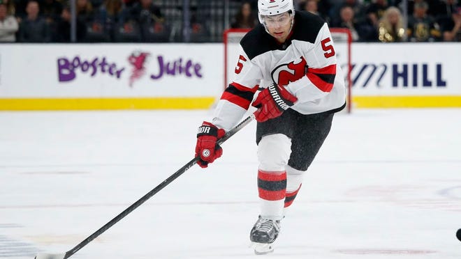 New Jersey Devils defenseman Connor Carrick (5) plays against the Vegas Golden Knights during an NHL hockey game Tuesday, March 3, 2020, in Las Vegas.