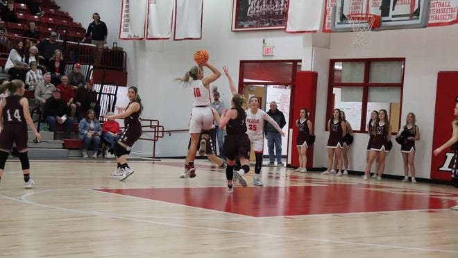Prague’s Taylor Hodges goes up for a shot Thursday night against the Perry Lady Maroons.