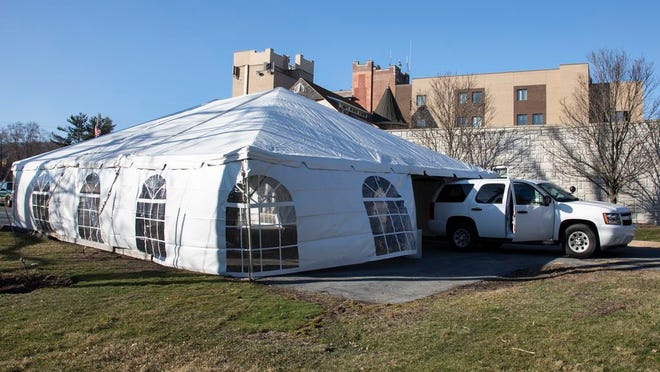 Workers on Sunday set up a tent at St. Anthony Community Hospital in Warwick which will be used as a drive-thru testing site for COVID-19.