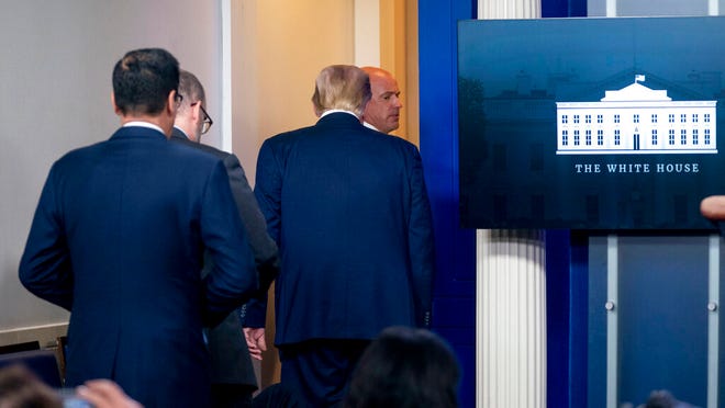President Donald Trump is asked to leave the James Brady Press Briefing Room by a member of the U.S. Secret Service during a news conference at the White House, Monday, Aug. 10, 2020.