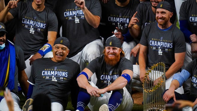 Los Angeles Dodgers manager Dave Roberts and third baseman Justin Turner pose for a group picture after the Dodgers defeated the Tampa Bay Rays 3-1 in Game 6 to win the baseball World Series, Tuesday, Oct. 27, 2020, in Arlington, Texas.