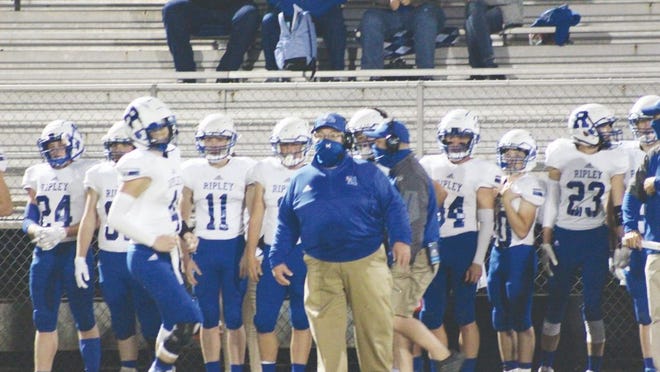 Viking's head coach Steve Sayre (blue jacket) looks on as his team takes the field against the Ravenswood Red Devils in the team's last regular-season game of 2020.