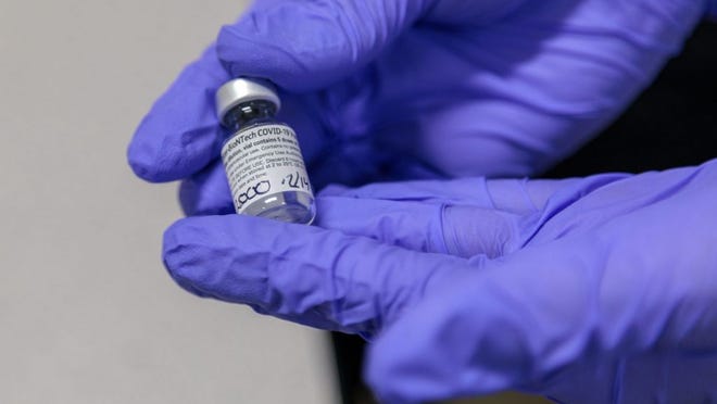 Doses of Pfizer's COVID-19 vaccine are prepped to be administered to healthcare workers on the frontlines at Truman Medical Center in Kansas City on Monday, December 14, 2020.