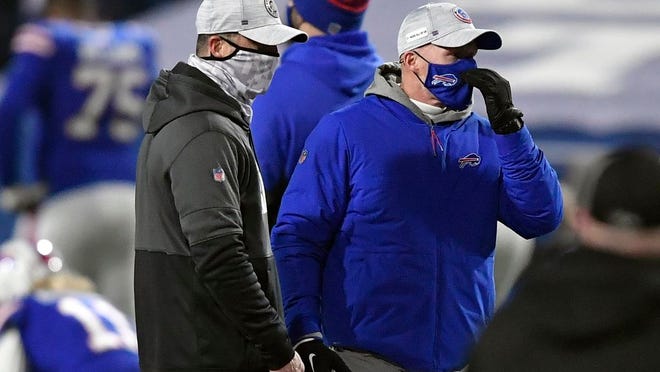 Baltimore Ravens head coach John Harbaugh, left, talks to Buffalo Bills head coach Sean McDermott before an NFL divisional round football game Saturday, Jan. 16, 2021, in Orchard Park, N.Y.