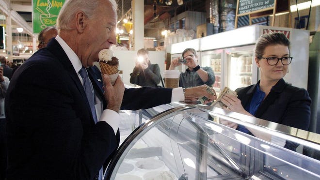 In this January 2012 file photo, then-Vice President Joe Biden, enjoys an ice cream cone from Jeni Britton Bauer, owner of Jeni's Ice Cream, during a brief stop at North Market.
