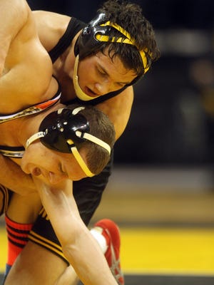 Iowa's Thomas Gilman wrestles Oklahoma State's Eddie Klimara at 125 pounds at Carver-Hawkeye Arena on Friday, Jan. 10, 2013. The two wrestlers will square off again on Saturday.