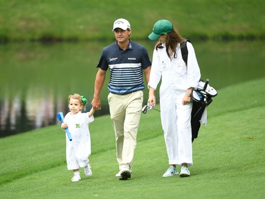 Kevin Kisner walks with daughter Kate and wife Brittany