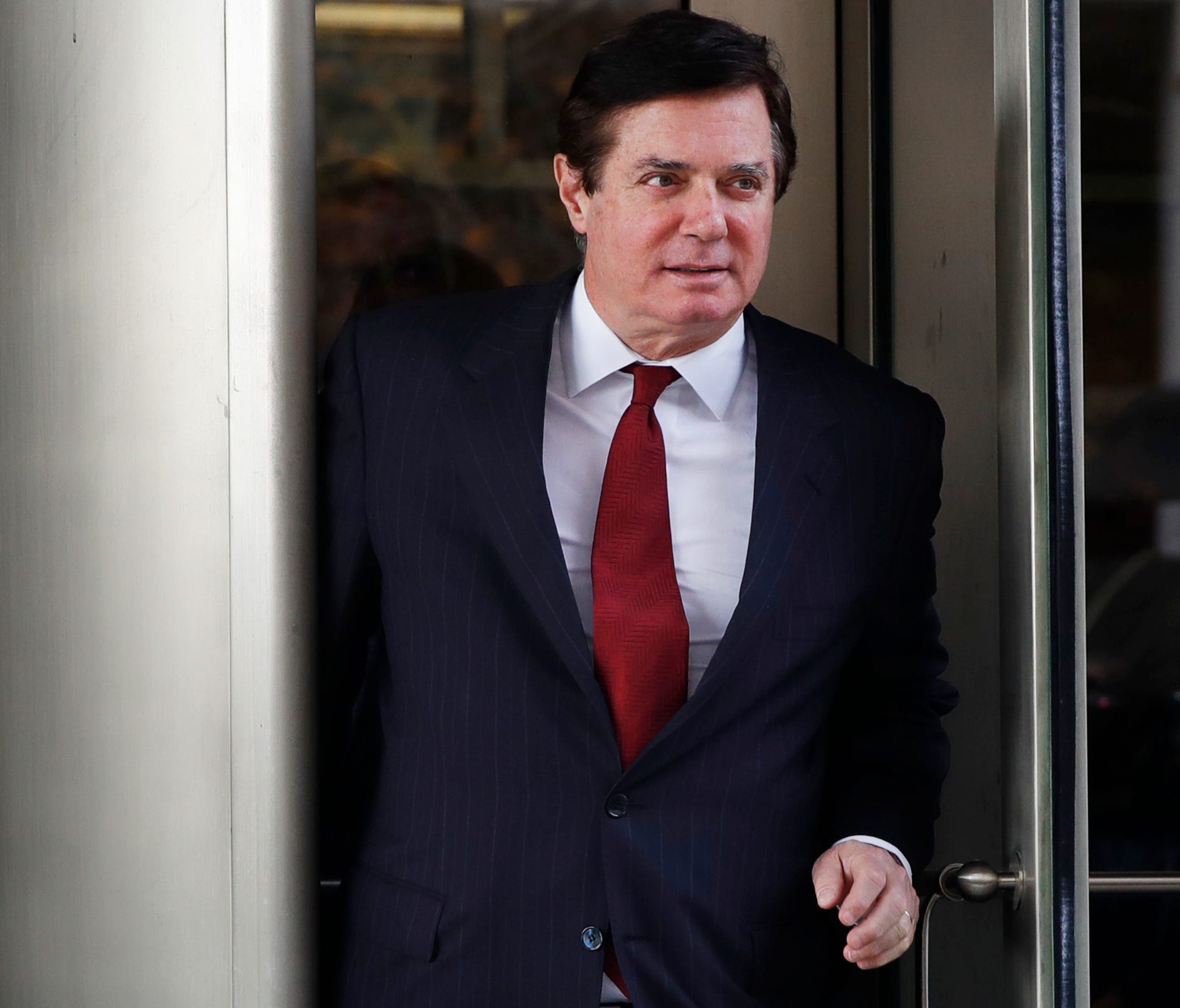 Manafort leaves a federal courthouse.