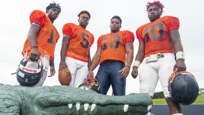 Football players (left to right) Martin McGhee (11), Z'khari Blocker (5), Shountrell Hills (13), and Amarquez Moore (10) at Escambia High School in Pensacola, FL on Monday, August 8, 2016.