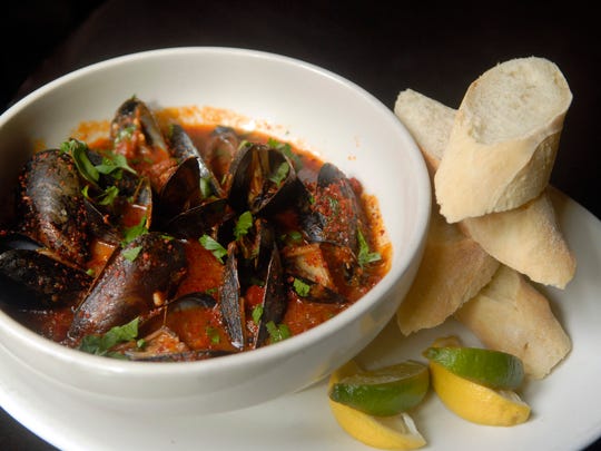 The Moules Basquaise: Chorizo, olive oil, lobster sofrito broth, piquillo peppers, Piment dÕEspelette, onions ($11.99 as an appetizer, $14.50 as an entree) at Mussel & Burger Bar on South 7th St.. Sept. 26, 2016