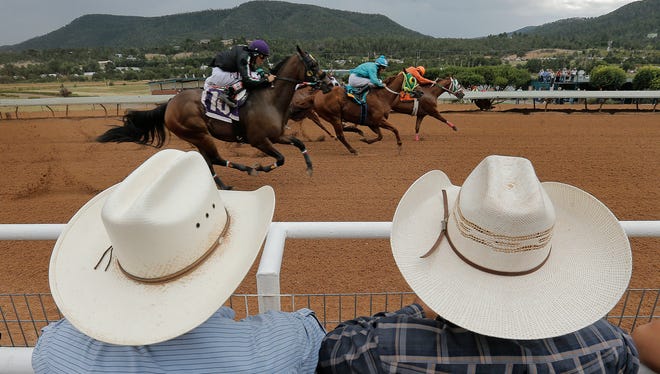 Race fans watch the races leading up to the All-American Futurity Monday at Ruidoso Downs.