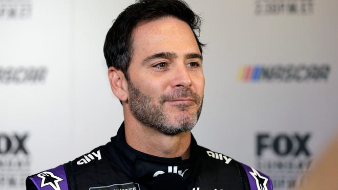 In this Feb. 13, 2019, file photo, driver Jimmie Johnson smiles during media day for the NASCAR Daytona 500 auto race at Daytona International Speedway in Daytona Beach, Fla. Seven-time NASCAR champion Jimmie Johnson has twice tested negative for the coronavirus and has been cleared to race Sunday, July 12, 2020 at Kentucky Speedway. Johnson missed the first race of his Cup career when he tested positive last Friday.
