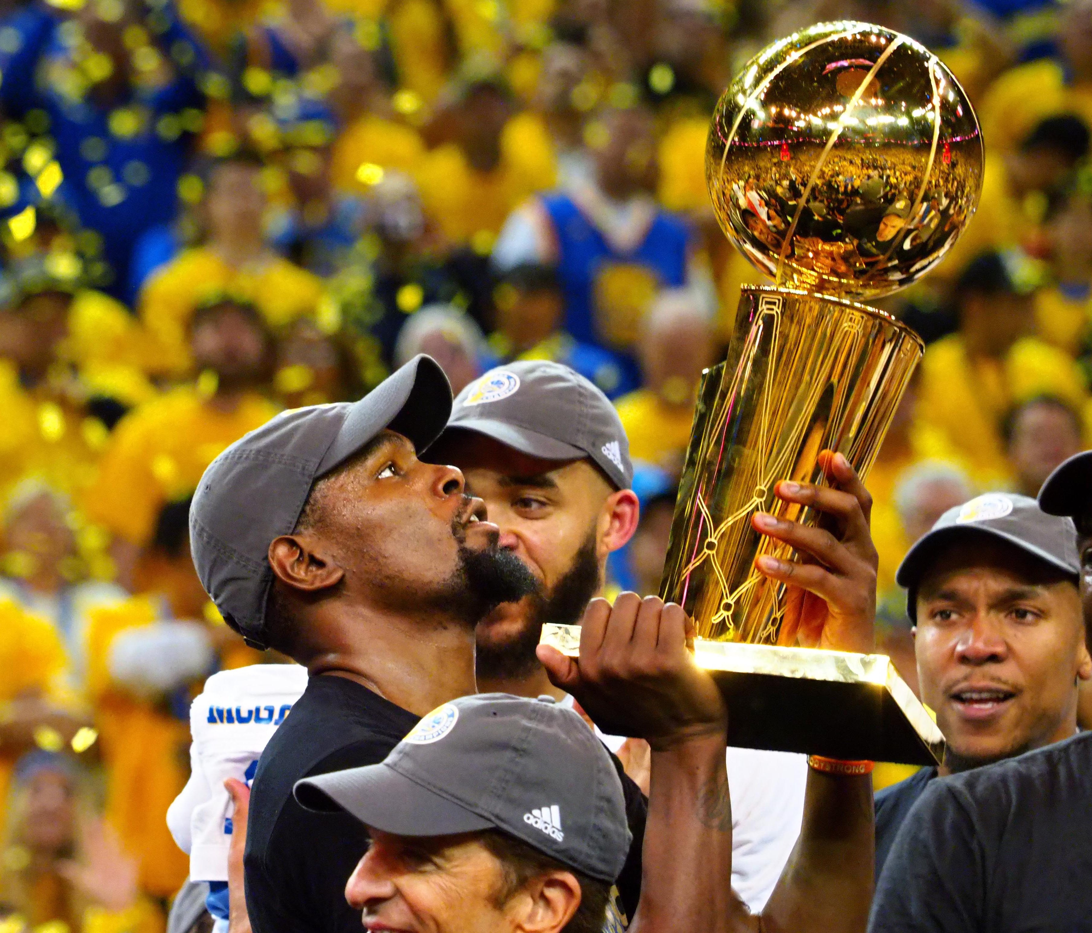 Golden State Warriors forward Kevin Durant (35) celebrates with the Larry O'Brien Trophy after beating the Cleveland Cavaliers in game five of the 2017 NBA Finals at Oracle Arena.